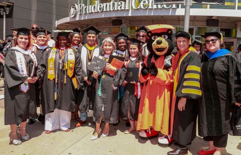 Adult learners gather after the undergraduate Commencement ceremony in May. Joining them, at the far right is President Richard Helldobler and Kara Rabbitt, associate provost for academic initiatives & adult and professional studies.